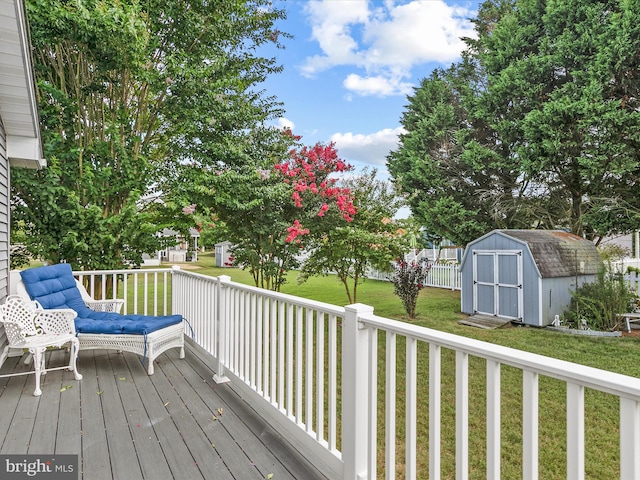 wooden deck with a yard and a storage shed