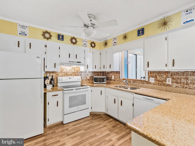 kitchen featuring white cabinetry, crown molding, and white appliances