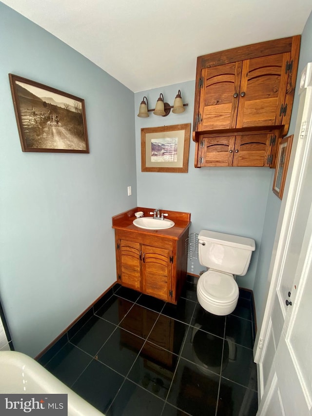 bathroom featuring tile patterned flooring, vanity, and toilet