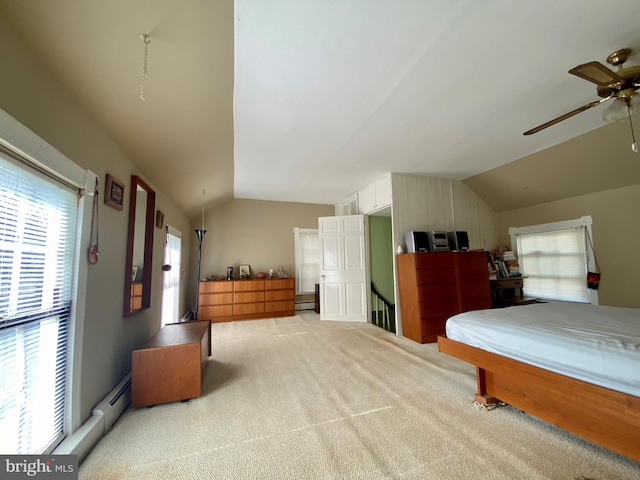 carpeted bedroom with a baseboard radiator, vaulted ceiling, and ceiling fan