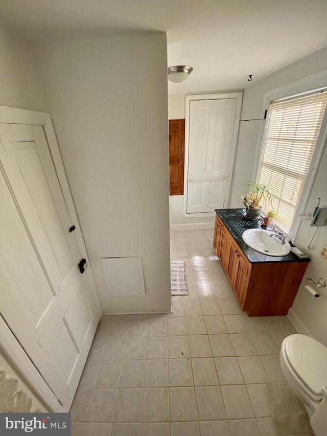 bathroom with tile patterned flooring, vanity, and toilet