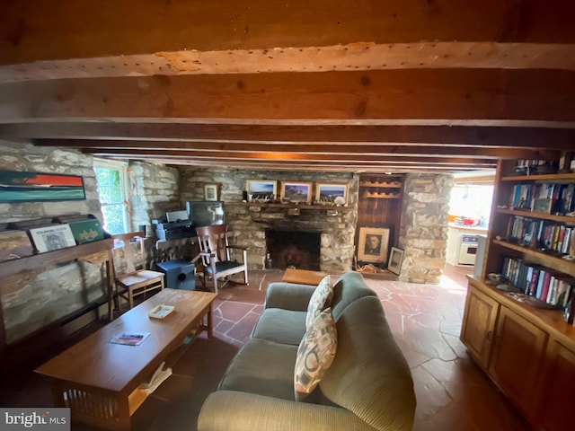 living room featuring a fireplace and beamed ceiling