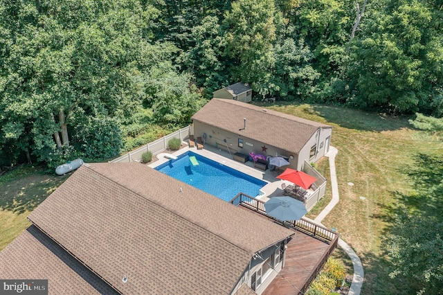 view of pool with a deck and a yard