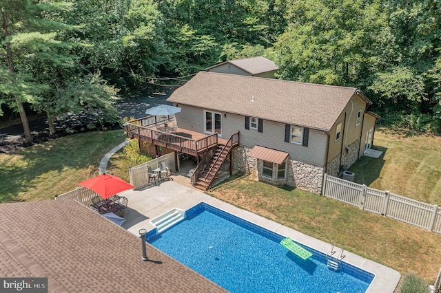 view of swimming pool with a patio area, a lawn, and a wooden deck