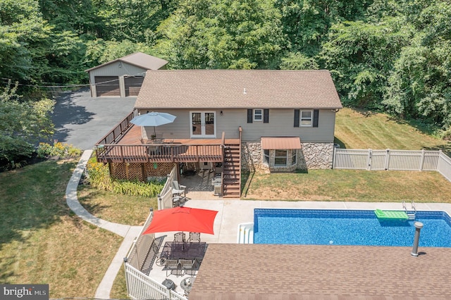 back of property with a patio, a lawn, and a swimming pool side deck