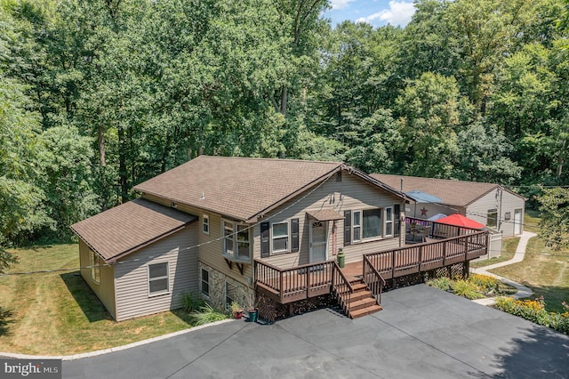 view of front of home with a deck and a front yard