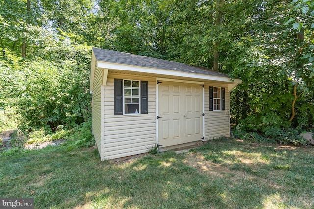 view of outdoor structure with a lawn