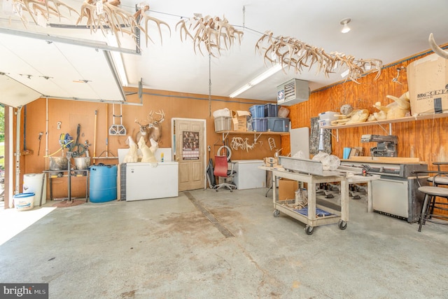 garage featuring refrigerator and a workshop area