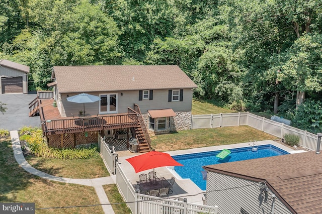 back of house featuring an outdoor structure and a pool side deck