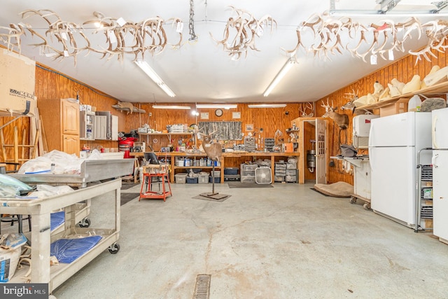 garage featuring white refrigerator and a workshop area