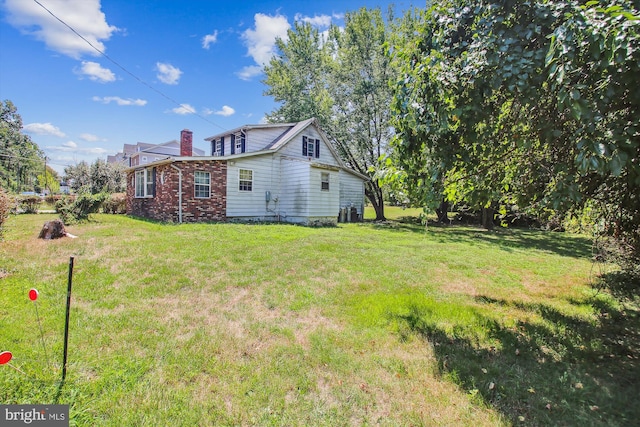 rear view of house with a yard