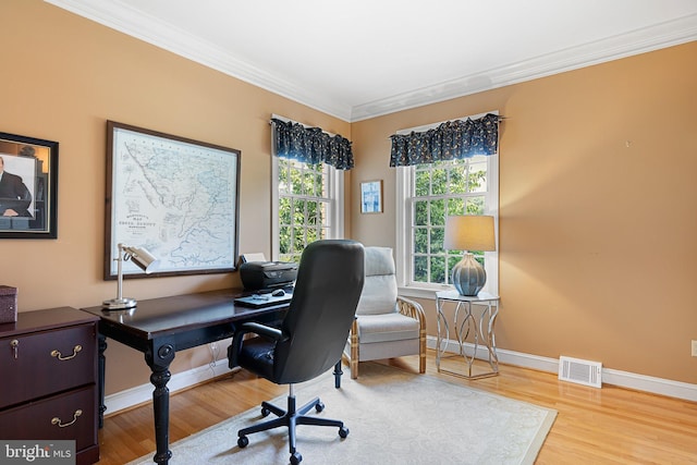 home office featuring light hardwood / wood-style floors and crown molding