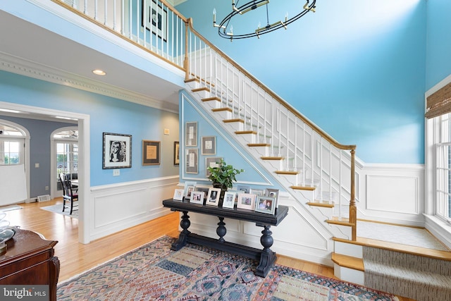 staircase featuring hardwood / wood-style floors and a chandelier