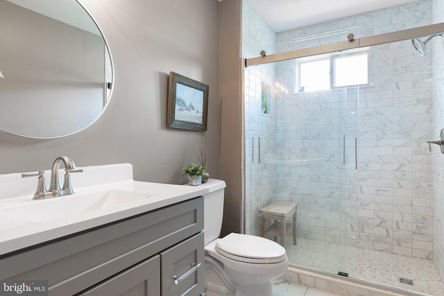 bathroom featuring vanity, toilet, and an enclosed shower