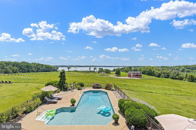 view of pool with a lawn, a rural view, and a patio