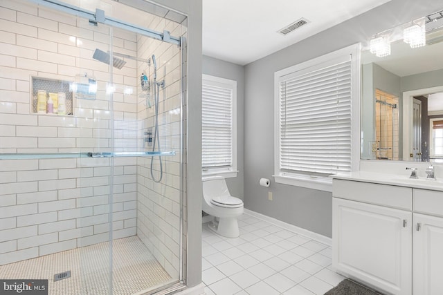 bathroom with tile patterned flooring, vanity, toilet, and a shower with shower door