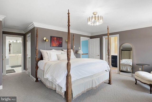 bedroom featuring light colored carpet, crown molding, and ensuite bath