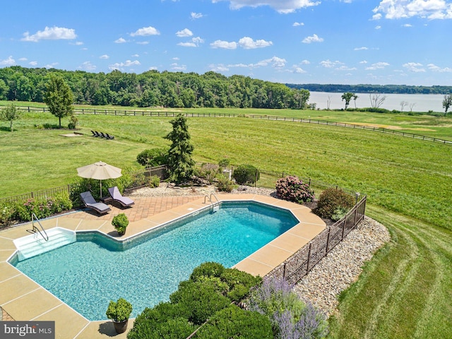 view of swimming pool with a lawn, a patio area, a water view, and a rural view