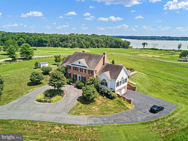 birds eye view of property with a water view and a rural view