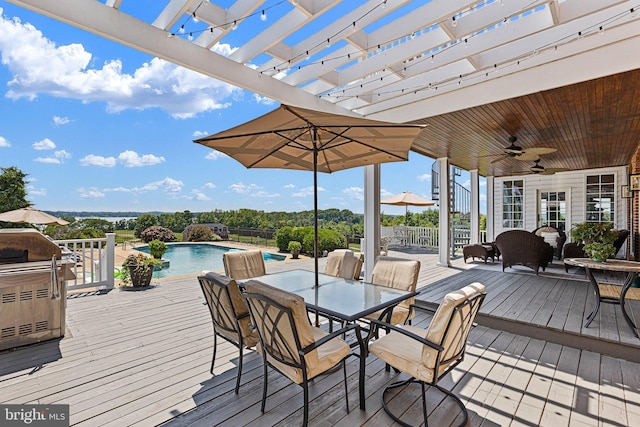 wooden deck featuring a pergola, a fenced in pool, pool water feature, and ceiling fan