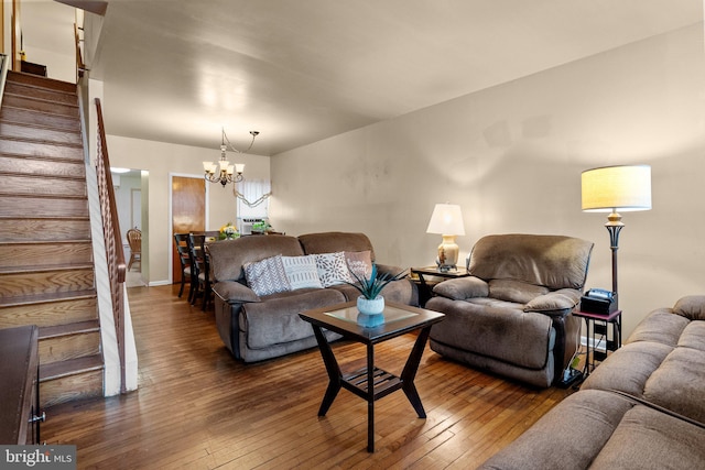 living room with dark hardwood / wood-style flooring and a notable chandelier