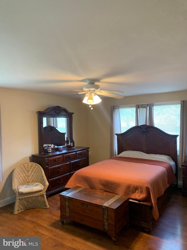 bedroom with ceiling fan and dark hardwood / wood-style floors