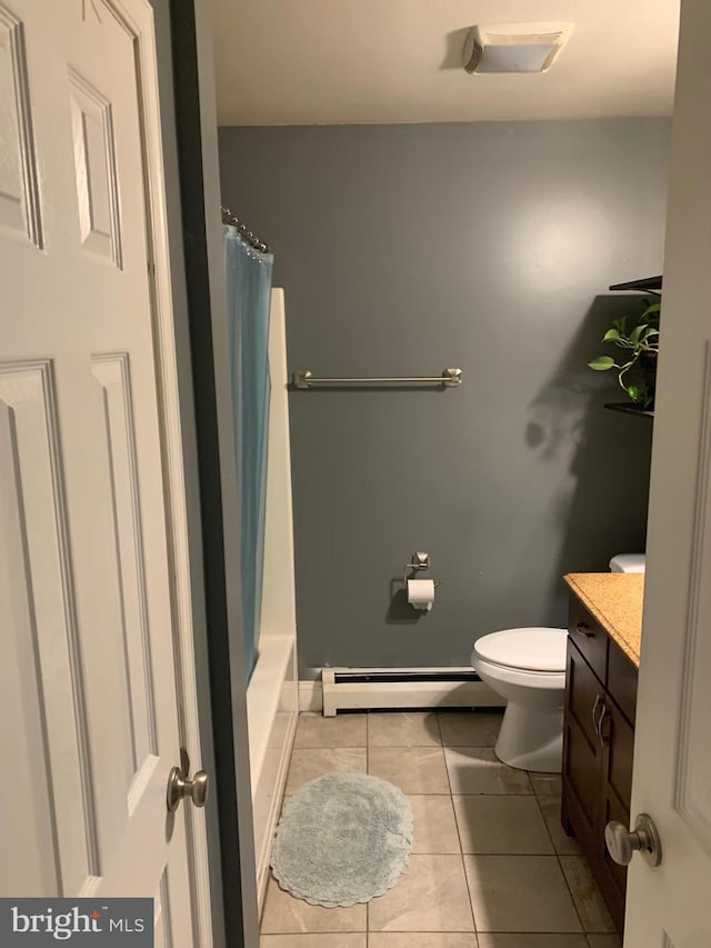 full bathroom featuring toilet, tile patterned flooring, a baseboard heating unit, shower / bath combo, and vanity