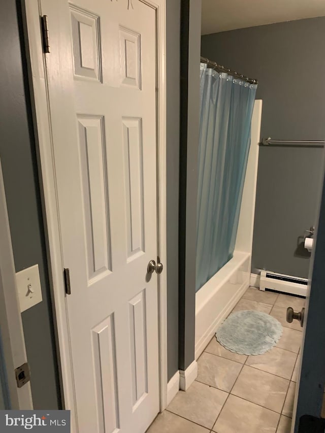 bathroom with shower / bathtub combination with curtain, tile patterned flooring, and a baseboard radiator