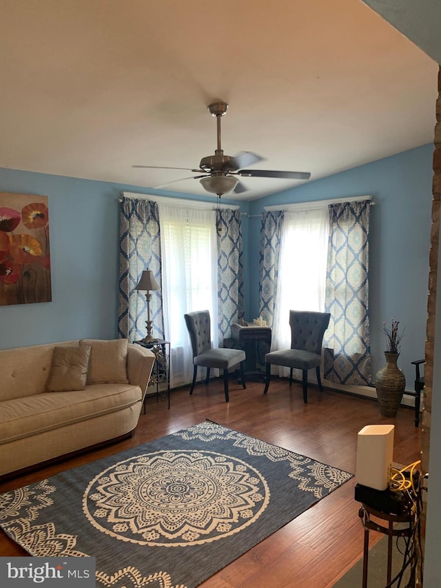 living room with ceiling fan and dark hardwood / wood-style floors