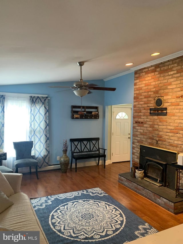 living room featuring ceiling fan, ornamental molding, and dark wood-type flooring