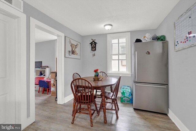 dining area with light wood-type flooring