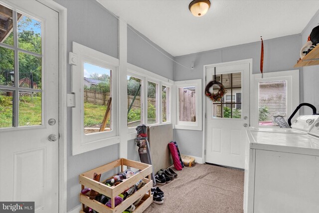 entryway featuring separate washer and dryer, plenty of natural light, and carpet floors