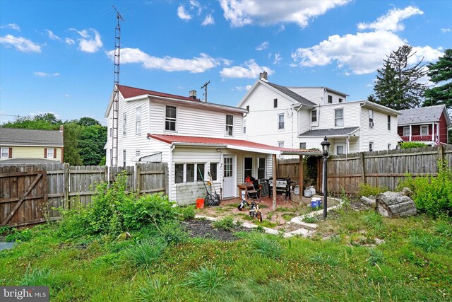 rear view of property featuring a patio area