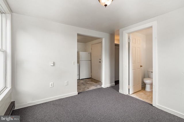 28 N 4th St, Steelton, PA 17113 - unfurnished bedroom with ensuite bath, light carpet, and white fridge
