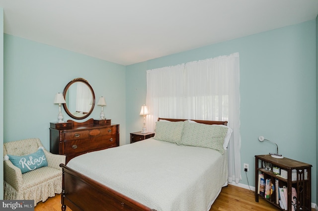 bedroom featuring wood finished floors and baseboards