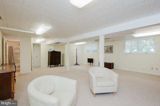 living room featuring light carpet and baseboards