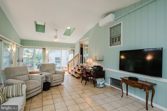 tiled living area with a wall mounted AC, a skylight, a ceiling fan, and lofted ceiling