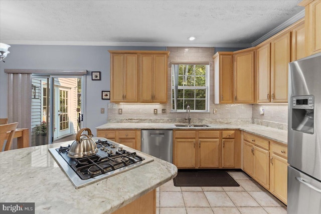 kitchen featuring crown molding, sink, light tile patterned floors, a textured ceiling, and appliances with stainless steel finishes