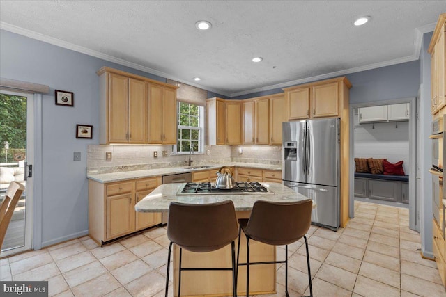 kitchen featuring light tile patterned flooring, stainless steel appliances, ornamental molding, and sink