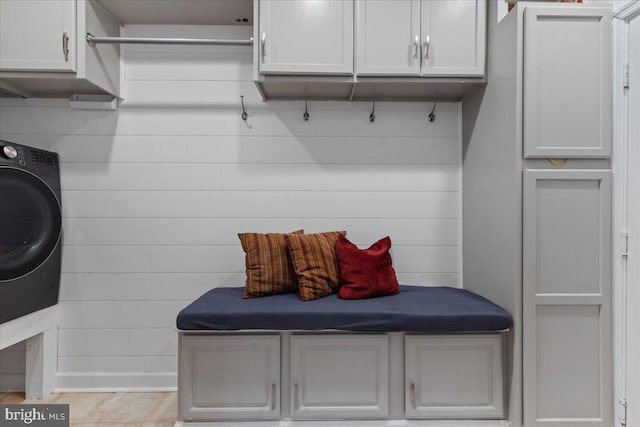 mudroom featuring wooden walls and washer / dryer