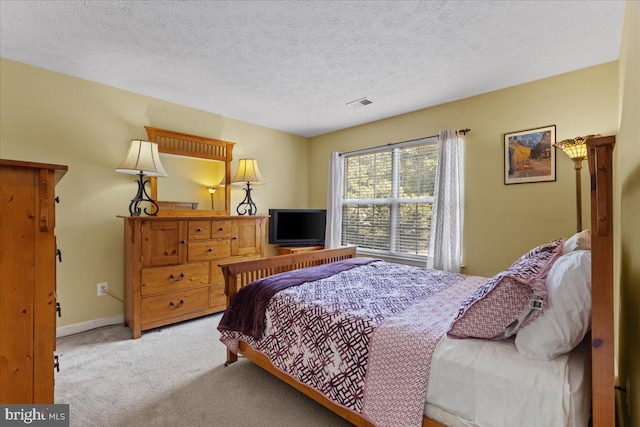 carpeted bedroom featuring a textured ceiling