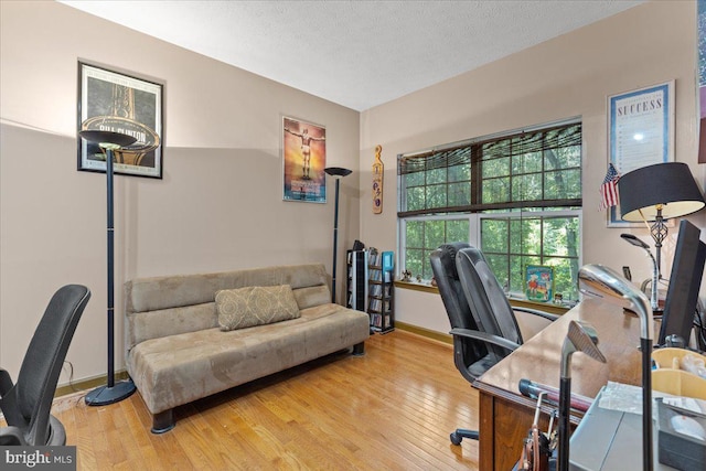 office area with a textured ceiling and hardwood / wood-style flooring