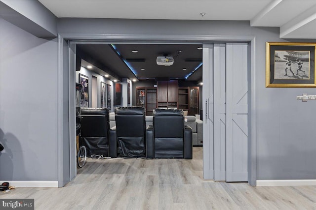 cinema room with light wood-type flooring