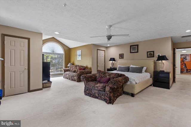 bedroom with vaulted ceiling, ceiling fan, light carpet, and a textured ceiling