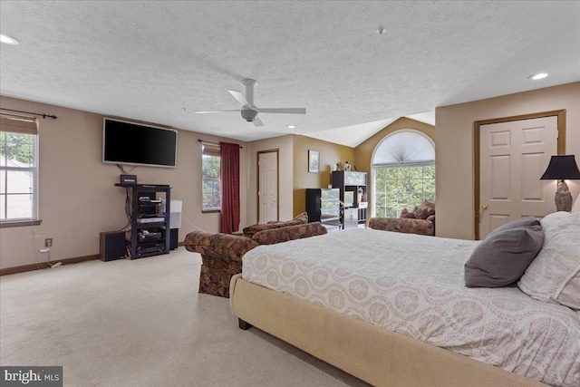 carpeted bedroom with multiple windows, a textured ceiling, and ceiling fan