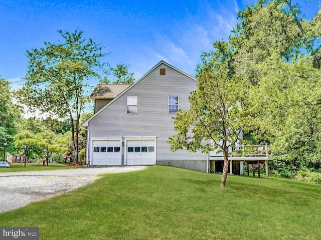 view of side of home with a garage and a lawn