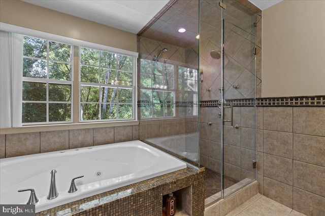 bathroom featuring tile patterned floors, independent shower and bath, and a wealth of natural light