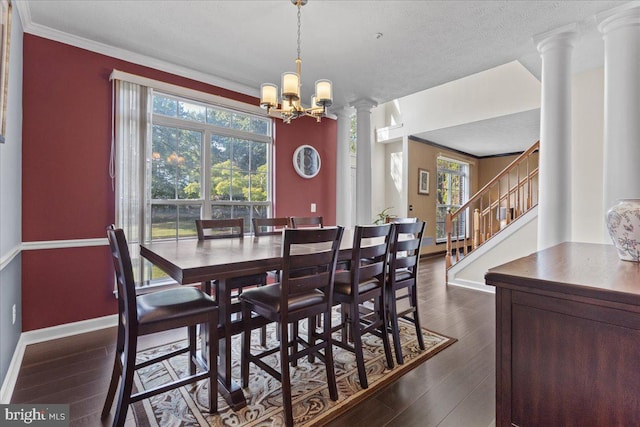 dining space featuring a chandelier, a textured ceiling, dark hardwood / wood-style flooring, and ornamental molding