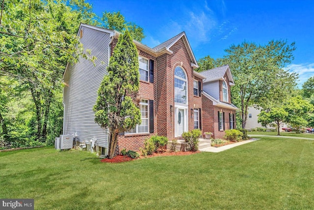 view of side of property with central AC unit and a lawn