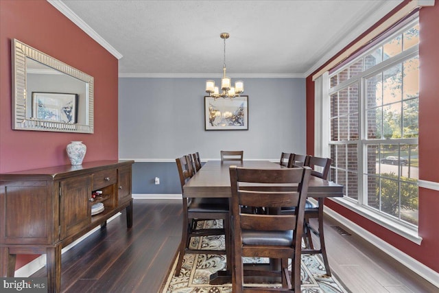 dining area with a wealth of natural light, dark hardwood / wood-style flooring, ornamental molding, and a notable chandelier